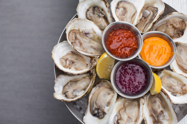 a plate of oysters and dips
